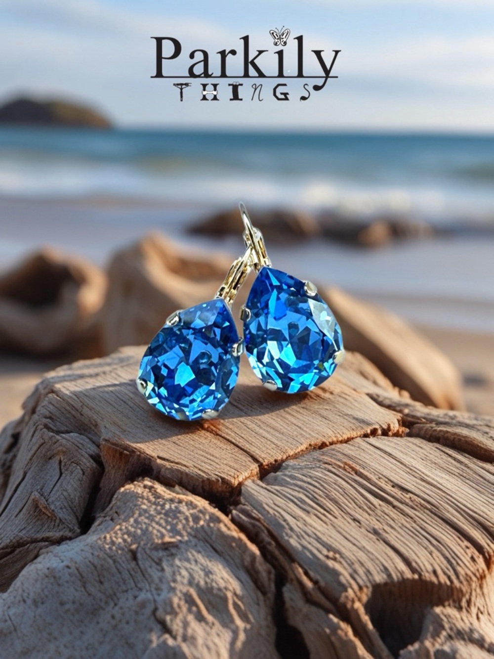 Handcrafted earrings with a very sparkly blue teardrop Swarovski crystal